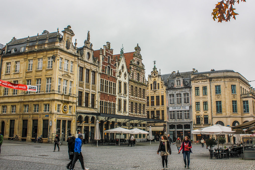 Grote Markt de Lovaina con edificios históricos y terrazas de cafeterías.