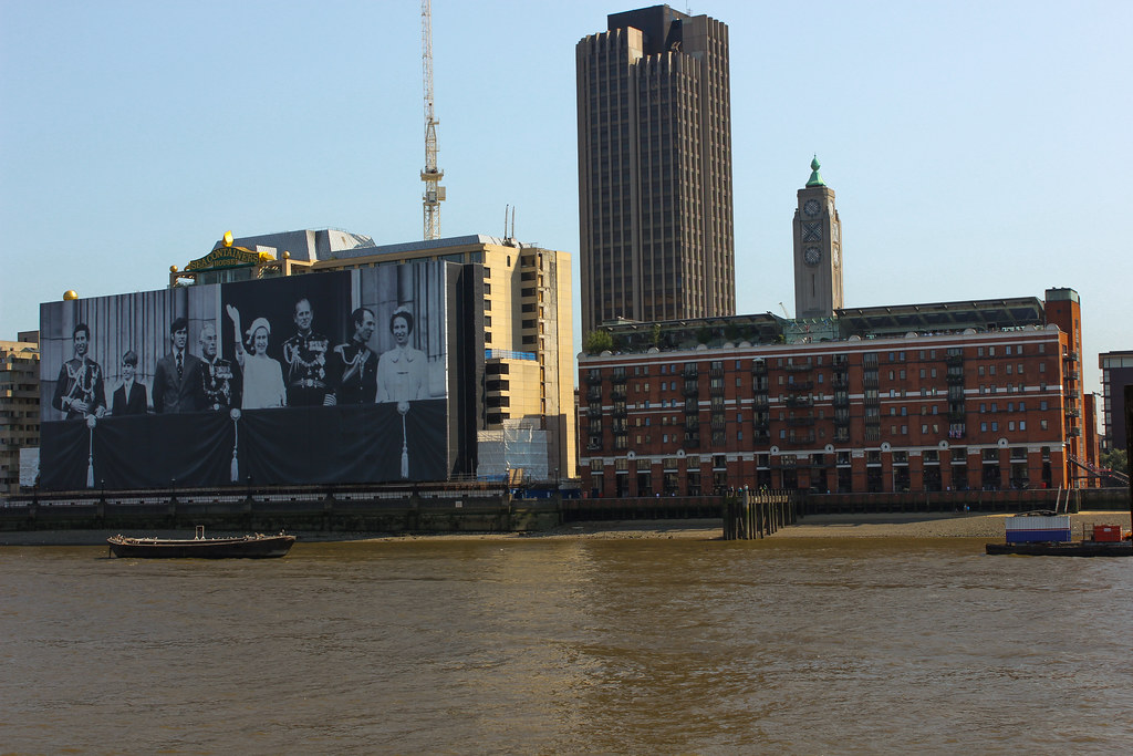 Edificio en Londres con un mural de la familia real británica junto al río Támesis.