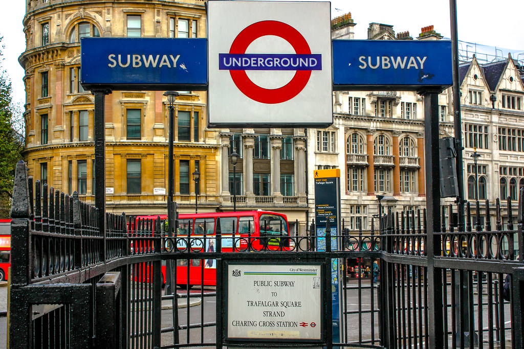 Señal de entrada al metro de Londres con logos de Underground y Subway cerca de Trafalgar Square.
