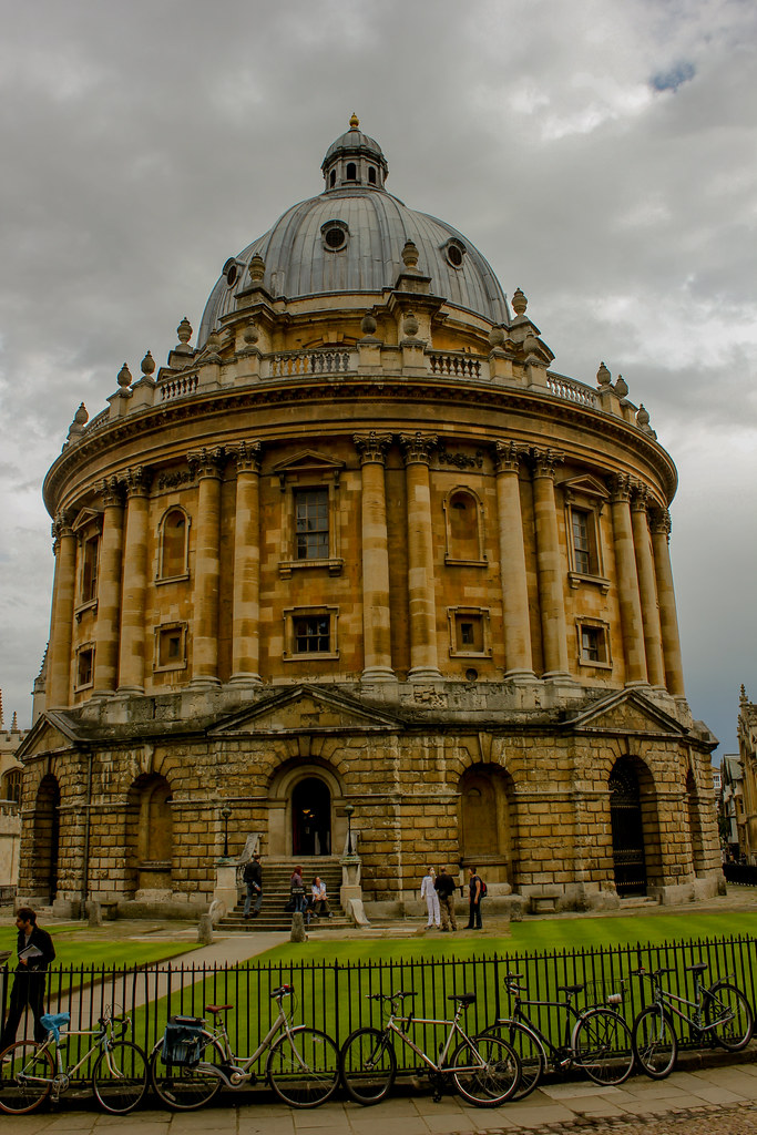 Radcliffe Camera, icónica biblioteca de la Universidad de Oxford, con bicicletas en primer plano.