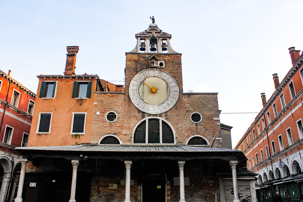 Reloj astronómico en la fachada de una iglesia en Venecia durante el día.