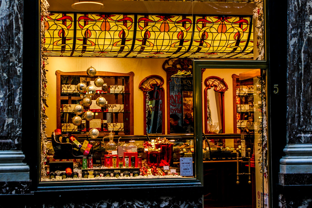Vitrina decorativa de una tienda con elementos de vidrieras y adornos navideños.